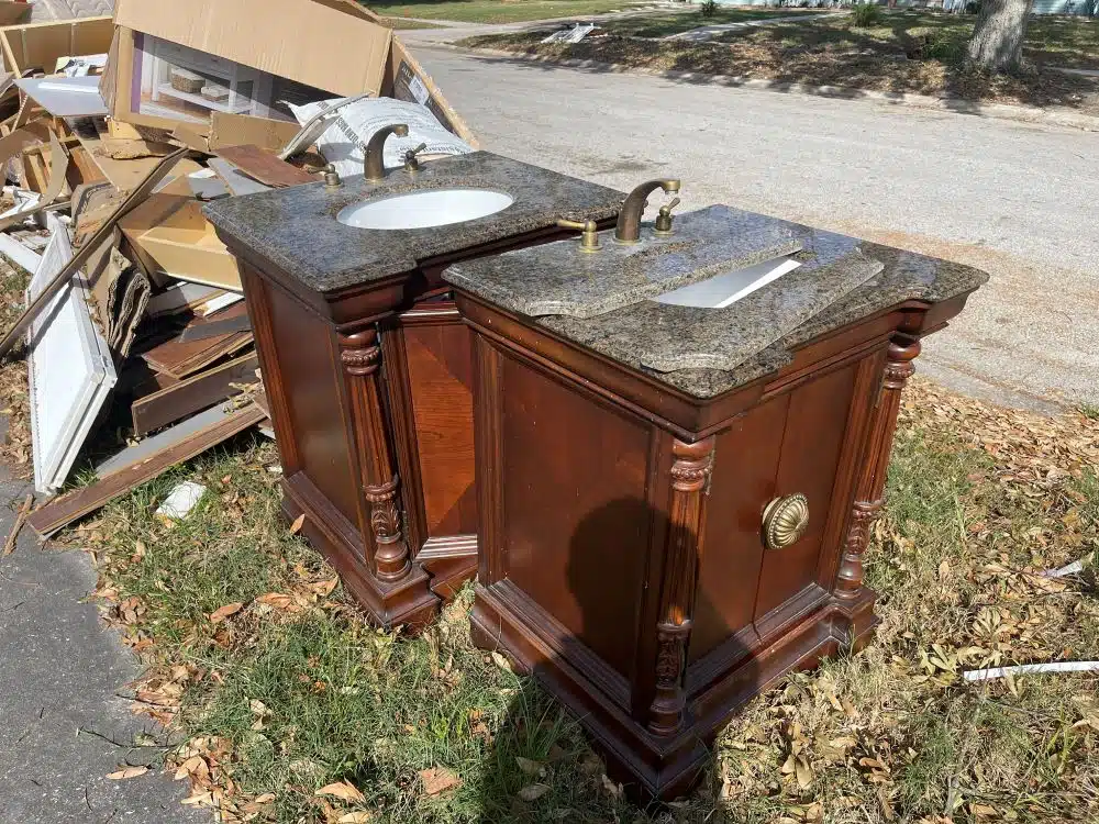 A pile of hurricane-damaged items, including furniture and appliances, indicating the aftermath of the storm.