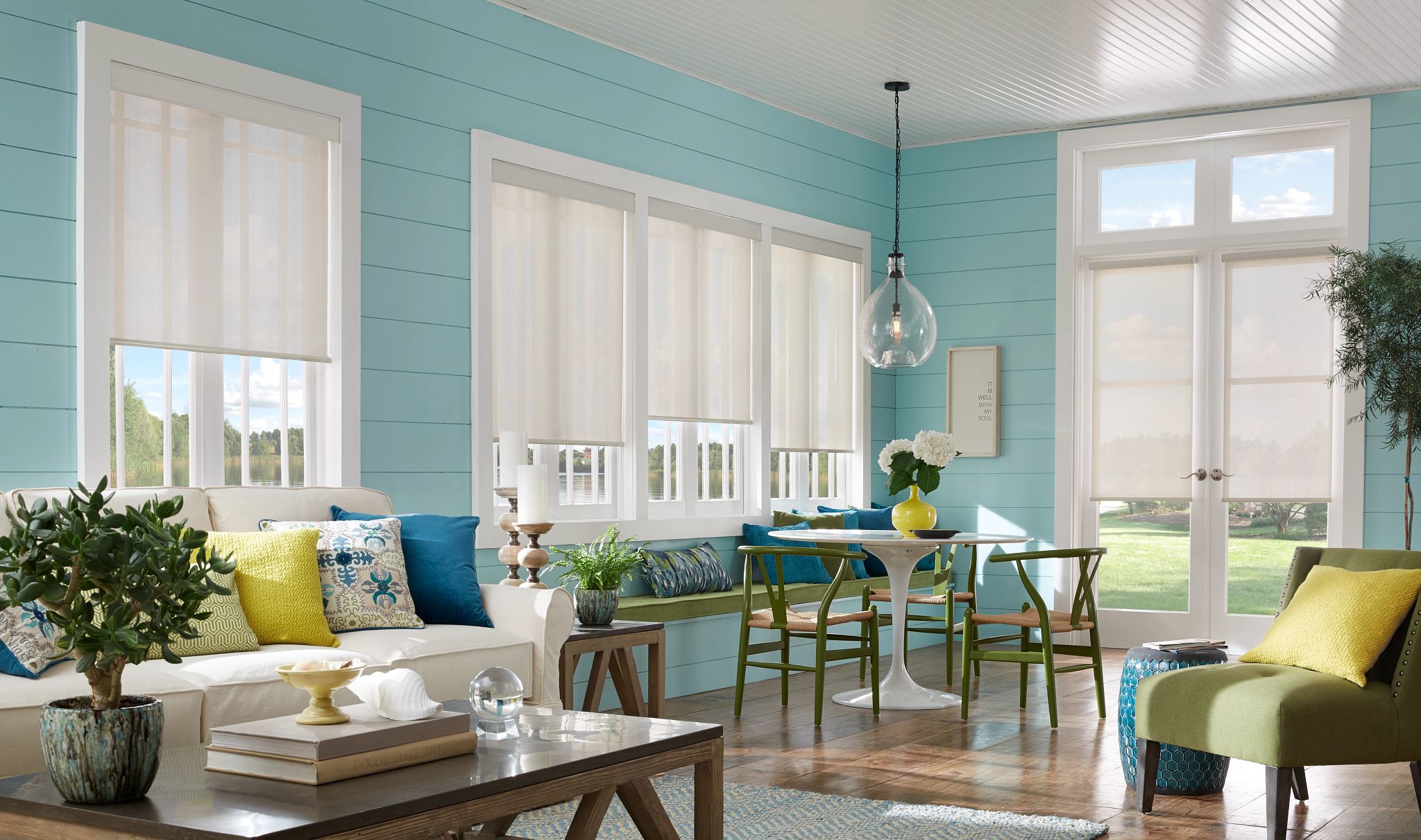 Modern living room in Tampa with motorized shades open, showcasing the view and the comfort of home automation.