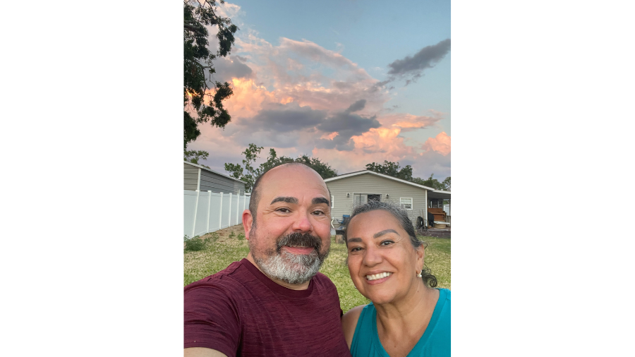 Roger and his wife smiling in a selfie against a stunning Florida sunset - bringing Shades In Place expertise to new horizons